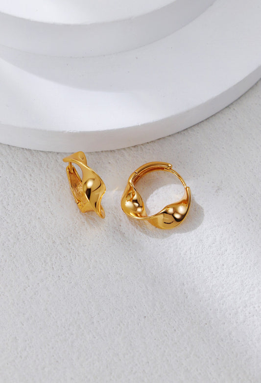 Twisted hoop earrings in gold with small bead-like details on the clasp