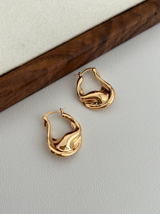 Vintage gold fluid hoop earrings, wavy sculpted profile