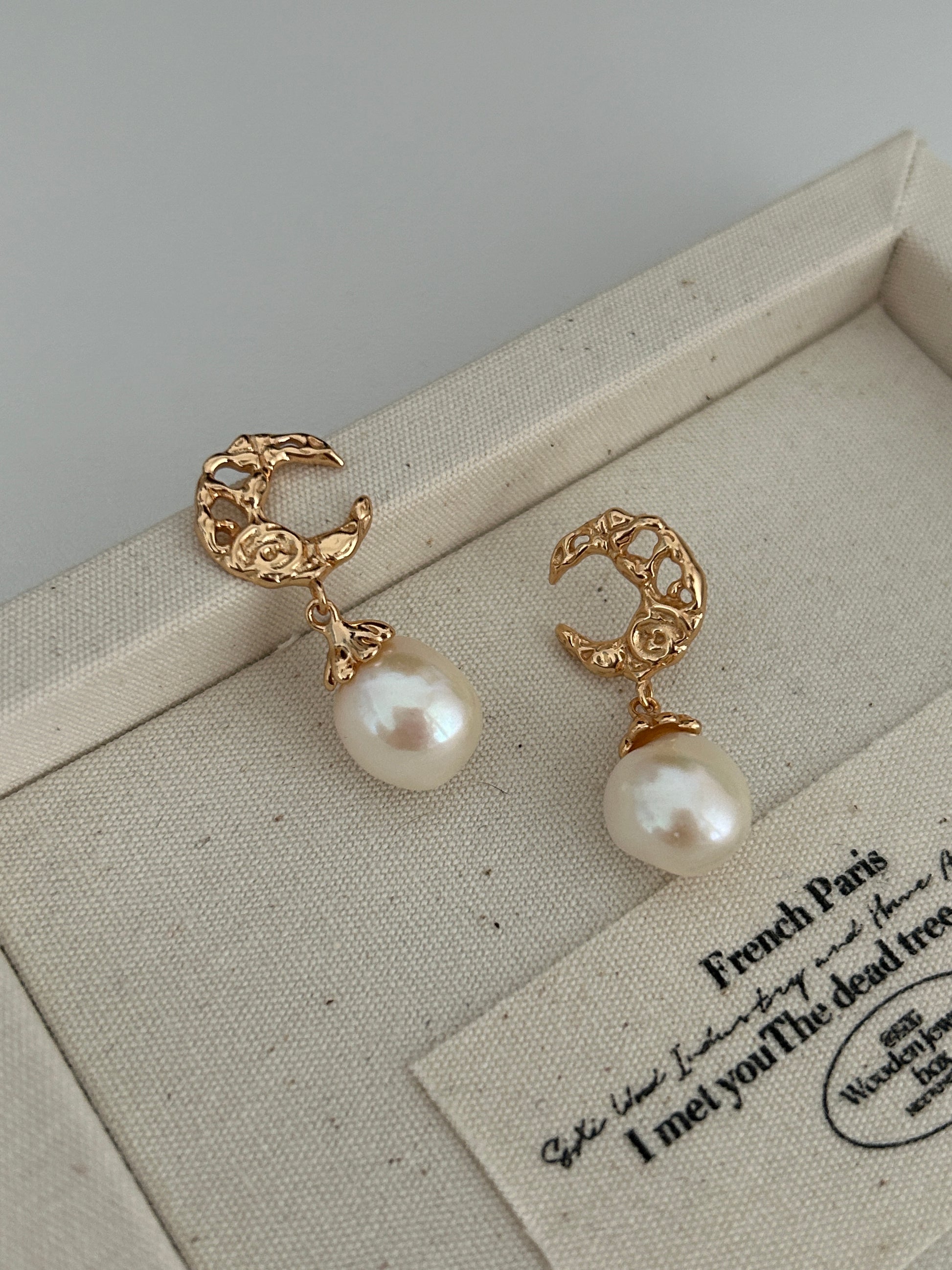 Gold-tone baroque hoop earrings with two dangling white pearls