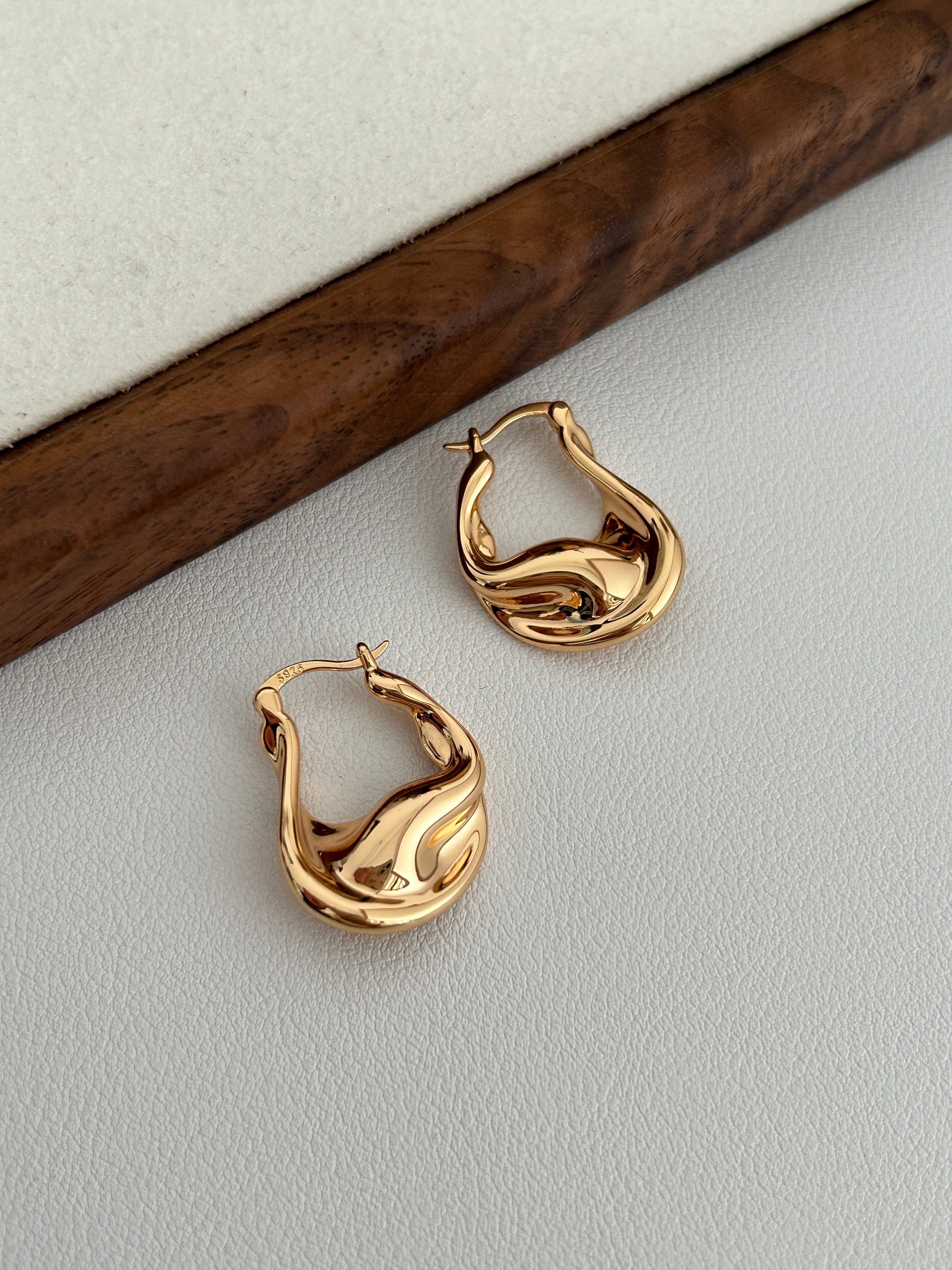 Vintage gold fluid hoop earrings, wavy sculpted profile