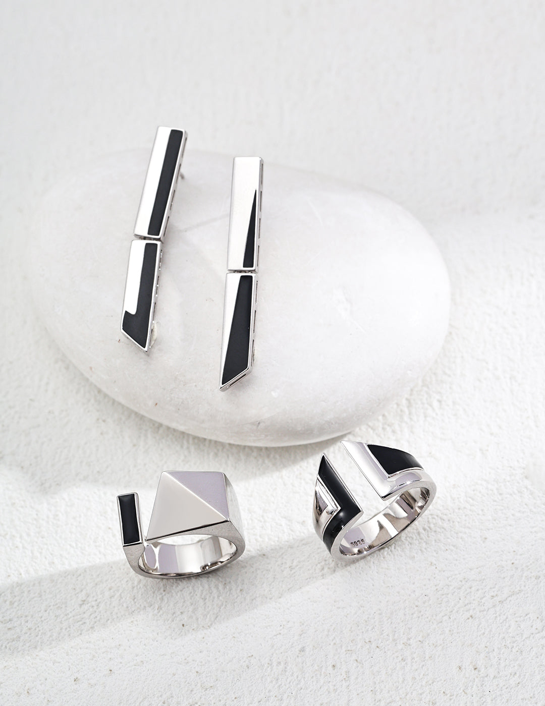 Sterling silver enamel rings with black rectangular insets, two angles