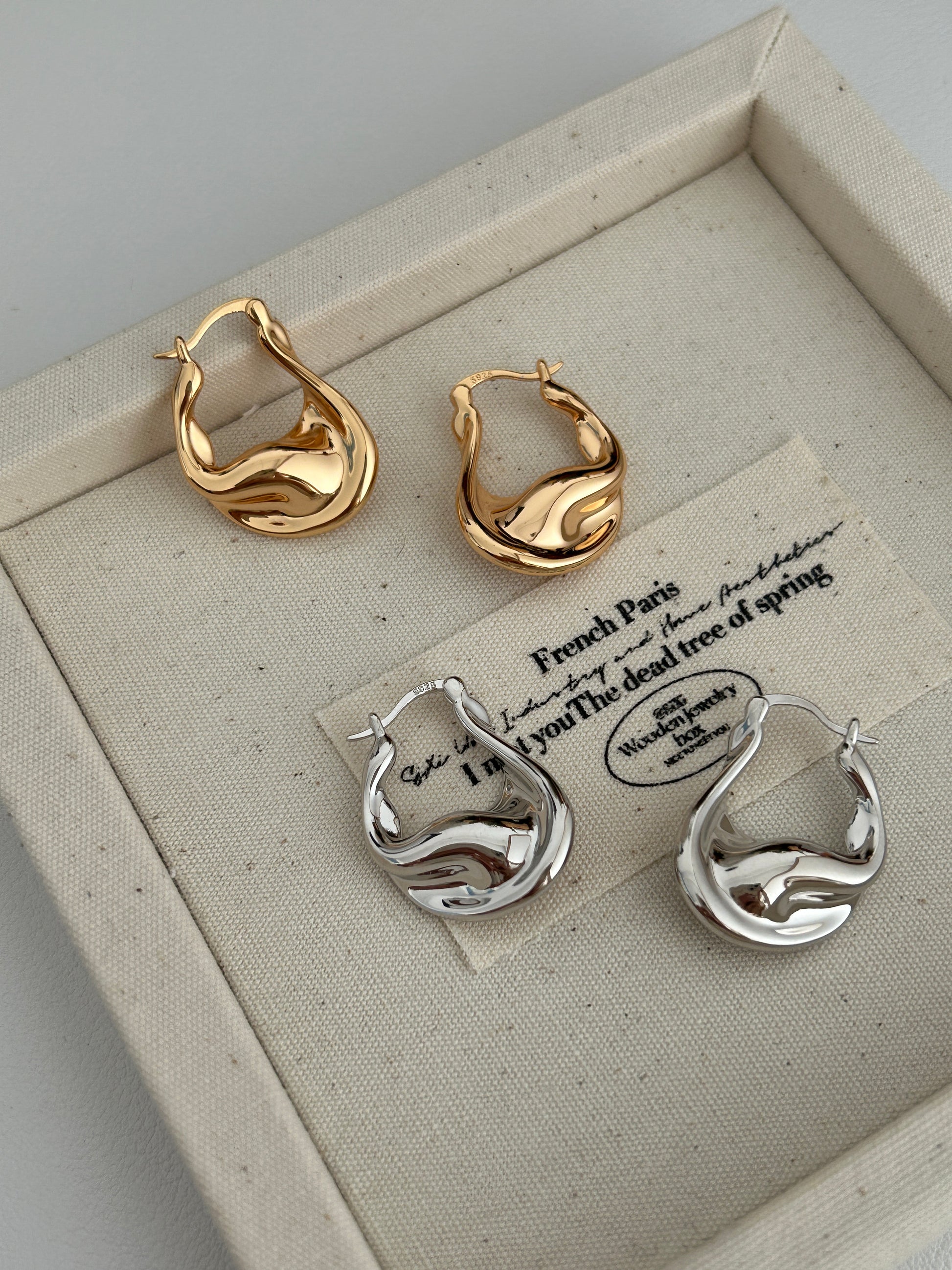 Gold and sterling silver fluid hoop earrings set, wavy sculpted profile