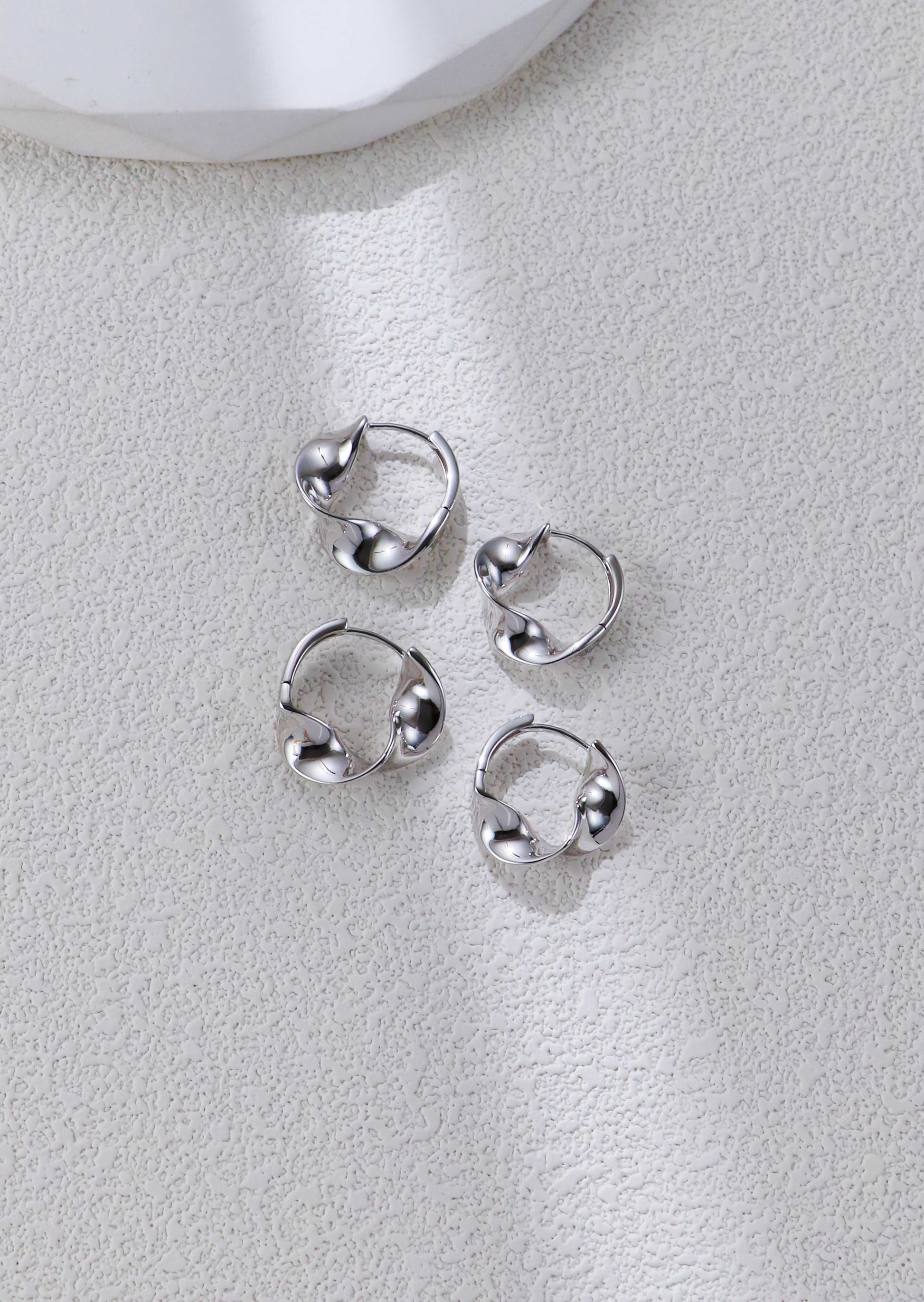 Set of twisted silver hoop earrings, circular twist with small bead-like details